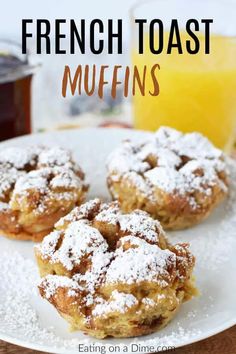 french toast muffins on a white plate with powdered sugar and orange juice in the background