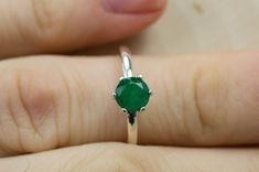 This is a beautiful Brazilian Emerald set in Sterling Silver. This amazing stone has the perfect deep green color that many look for in Emeralds accented beautifully by a 6 prong setting! This stone has visible inclusions and opaque clarity which is very common with Emeralds but also has a nice luster, you will not be disappointed!  Emeralds are the birthstone for May!  This perfect sized 6mm round cut Emerald weighs 0.740 and will go great with most styles or occasions. The size of these perfec Sterling Silver Emerald Ring With Vvs Clarity, Emerald Gemstones With Center Stone In Round Cut, Round Cut Emerald Gemstone With Center Stone, Elegant Green Gemstones With Prong Setting, Classic Green Heart Cut Rings, Classic Green Gemstone With Center Stone, Green Heart Cut Emerald Ring For Formal Occasions, Heart Cut Green Emerald Ring For Formal Occasions, Elegant Heart Cut Green Emerald Ring