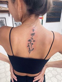 a woman with a flower tattoo on her back