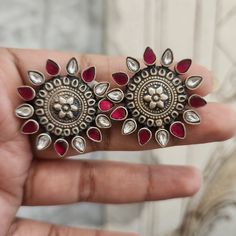 Add a touch of vintage charm to your look with these Oxidized Studs. Featuring a floral design with pink and white kundans, these studs are perfect for making a stylish statement. Ideal for both casual and festive occasions, they bring a blend of traditional and contemporary elegance to any outfit. Material: 92.5 oxidized silver Stones: Semi precious kundans Vintage Jhumkas For Wedding, Festive Gota Work Earrings For Designer Wear, Festive Designer Gota Work Earrings, Multicolor Oxidized Wedding Earrings, Ornate Round Earrings With Oxidized Finish, Ornate Oxidized Earrings For Festive Occasions, Ornate Oxidized Round Earrings, Bohemian Multicolor Oxidized Finish Earrings, Pin Pendant