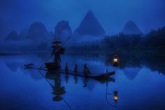 a group of people riding on top of a boat in the middle of a lake