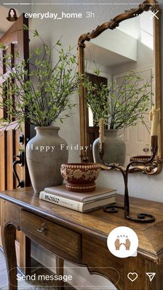 a table with two vases on it and a mirror above it that says happy friday