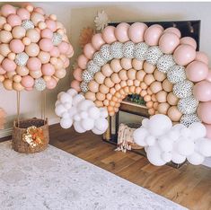 balloons are arranged in the shape of an arch, and on top of a table