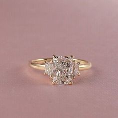 a yellow gold engagement ring with an oval cut diamond