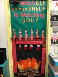 a classroom door decorated to look like an elf's fireplace with stockings on it