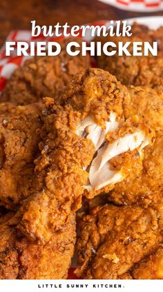 fried chicken on a red and white checkered plate with buttermilk in the background