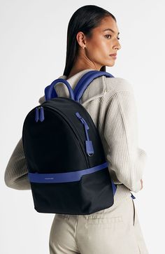 Our sleekest carryall, now crafted from a revolutionary water, stain and knock-resistant fabric. The Resilon Nylon Backpack, a 100% recycled water-resistant yarn produced from discarded fishing nets, is coupled with full-grain leather accents to create an ultra-durable unisex bag featuring six external zip-and-slip pockets and four more inside. Evenly distributing weight through densely padded straps and backing, our original icon is reimagined with enhanced security through an added recessed fr Luxury Blue Backpack With Adjustable Strap, Blue Rectangular Leather Backpack With Adjustable Strap, Modern Blue Backpack With Zipper Pocket, Luxury Blue Standard Backpack, Blue Backpack With Zipper Closure, Fishing Nets, Lapis Blue, Leather Accents, Polish Silver