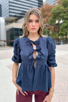 Transition into fall effortlessly with this stunning navy 3/4 sleeve top. This top offers a vibrant color that's ideal for the season, plus three front bows that add the perfect amount of detail. Its loose fit makes it versatile enough to pair with high-waisted jeans or a skirt for a playful look during the day or a laid-back vibe at night! Model is wearing a size small: Height: 5'10" Bust: 34" Waist: 24" Maxi Romper, Bow Top, During The Day, High Waist Jeans, Sweater Top, Sweaters & Cardigans, Jumpsuit Romper, Sleeve Top, Loose Fitting