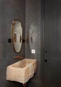 a bathroom sink sitting under a mirror next to a doorway