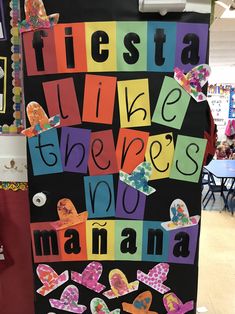 a bulletin board with words written in different colors and shapes on it that read fiesta vies there's no manana