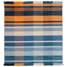 an orange, blue and grey plaid rug with fringes on the bottom half of it