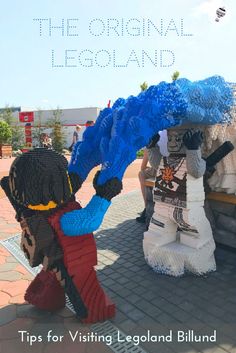 the legoland entrance is decorated with blue and white decorations, including two men holding an umbrella