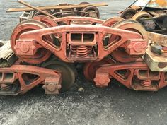 an old rusted train car sitting on top of some other rusty tracks and wheels