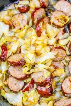 sausages and cabbage in a crock pot ready to be cooked