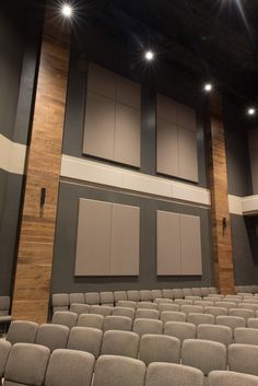 an empty auditorium with rows of seats and lights