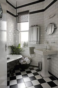 a bathroom with black and white checkered flooring, a claw foot bathtub