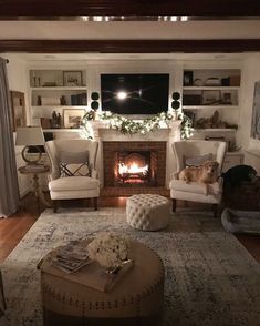 a living room filled with furniture and a fire place in the middle of the room