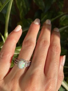 White Opal Birthstone Ring, Oval Solitaire Opal Ring Fine Jewelry, Oval Opal Ring In White Gold, Oval Opal Promise Ring With Accent Stones, Sterling Silver Opal Ring For Wedding, Oval Cabochon, Silver Opal Ring With Halo, Silver Opal Jewelry With Halo, Oval Opal Promise Ring With Halo, Oval Solitaire Opal Jewelry