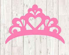 a pink princess tiara with hearts cutout on the front and back of it