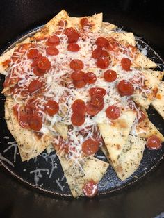 a pizza with cheese and pepperoni on it in a skillet