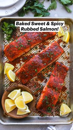 baked salmon in a baking pan with lemons and parsley on the side text reads spice rubbed oven baked oven baked salmon