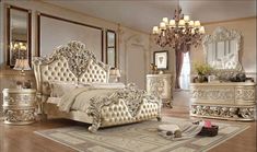 a fancy bedroom with white furniture and chandelier