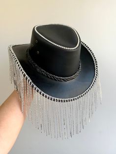 Genuine Leather cowboy hat embellished with rhinestone fringe for the Dollies of the disco The perfect addition to your festival outfits One size: 57cm Hat has an adjustable chin strap Free UK delivery Fancy Cowboy Hat, Festival Hats With Rhinestones And High Crown, Festival Hat With Rhinestones And High Crown, Festival Hats With Rhinestones And Short Brim, Festival Fedora Hats With Rhinestones, Adjustable Embellished Hat For Festivals, Adjustable Embellished Festival Hats, Western Party Hat With Rhinestone Fringe, Western Style Adjustable Hat With Rhinestone Fringe