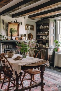 a dining room table and chairs in front of a window