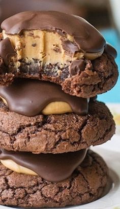 three cookies stacked on top of each other with chocolate frosting and peanut butter in the middle