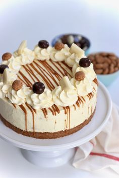 a cake with white frosting and chocolate chips on top