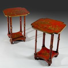 two small tables sitting next to each other on top of a white table covered in red and gold paint