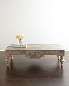 a white coffee table sitting on top of a hard wood floor