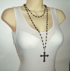 This is one of those stunning pieces that will become an instant favorite of yours (and the instant envy of your friends Featuring black hematite beads that have a magical sparkle and depth of their own, this beaded double chain cross necklace has a gorgeous filigree cross hanging on the end of the longer chain. Lengths of the chain can be adjusted, but currently measure 17 inches (shorter chain) and 35 inches (longer chain). Long Cross Necklace, Black Rosary, Cross Chain Necklace, Black Cross Necklace, Necklace Outfit, Diy Jewelry Projects, Gothic Necklace, Rainbow Necklace, Original Characters