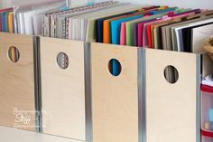 a wooden box filled with lots of folders next to a basket full of files