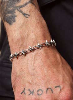 Not fort he faint of heart. This is one of our coolest and unexpected styles, yet we totally love it and screams evolution and metamorphosis which is the whole theme of our 2024 collections. Thick, double sided sterling silver spikes intertwined with oval cable rope style links. Comes in adjustable style with extender to fit most men's wrist sizes. Chain width: 11 mm (tip of spike to tip of spike) Material: 925 Sterling Silver Clasp: Gunmetal Sterling. Lobster Claw. Size: Adjustable. Fits wrist Gothic Bracelet, Stainless Bracelet, Cord Bracelets, Bracelet Stack, Men Necklace, Gemstone Necklace, Lobster Claw, Chain Bracelet, Bracelets For Men