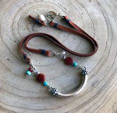 "A fabulous leather gemstone silver necklace captures the essence of the desert southwest. A stunning important pewter curved tube with decorative ends serves as the focal while turquoise, fire agate, carnelian, freshwater pearls, Swarovski bicone crystals and Karen Hill Tribe fine silver combine to create a gorgeous necklace with a definite southwest vibe. Great on its own and also as a layering piece, it closes with an easy to manage substantial silver plated lobster claw clasp and rope link. Beading Board, Sundance Style Jewelry, Gold Pearl Bracelet, Desert Southwest, Nugget Bracelet, Sundance Style, Blue Stone Necklace, Citrine Jewelry, Special Gifts For Her