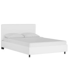 a white bed with two pillows on top of it and a night stand underneath the headboard