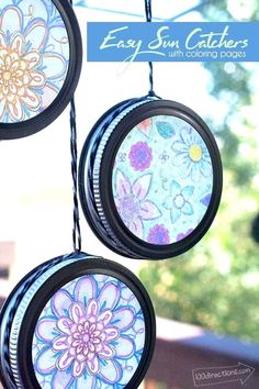 three sun catchers hanging from a wire with flowers painted on them and the words easy sun catchers