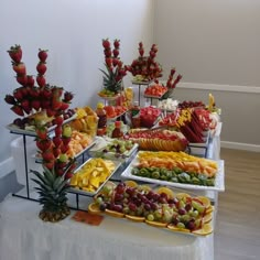 a table filled with lots of different types of fruits and veggies on it