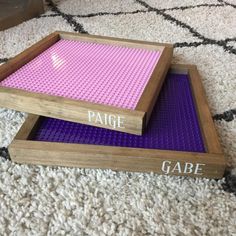 two wooden trays sitting on top of each other with purple and pink lego blocks