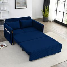 a blue couch sitting on top of a white rug