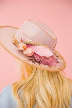 Unleash some playful style with the RIDIN DERBY PINK RANCHER HAT! This one-of-a-kind hat features a pink color palette with bold gold accents and a cream ribbon band. A racing horses design, gold horse bit patch, and pink floral design add a unique touch, perfect for an unforgettable Derby look. Giddy up! This hat is ONE OF A KIND, created by our owner Stephanie. To receive item quicker, expedited shipping is available at checkout. Pink Flat Brim Hat Bands For Country Events, Pink Western Hat For Kentucky Derby, Pink Fedora For Kentucky Derby And Rodeo, Pink Short Brim Mini Hats For Country Events, Pink Hat For Kentucky Derby And Country Events, Pink Fedora With Flat Brim For Party, Pink Flat Brim Fedora For Party, Pink Fedora For Kentucky Derby Party, Pink Flat Brim Hat For Races