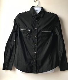 Size: L Brand: Daang Goodman for Tripp NYC Closure: Snaps This MENS black dress shirt features metal rivet snaps in the front and shoulder and zippers on the functional front pockets. Condition: Preowned vintage great. Only worn a few times. No rips, stains or imperfections. Black Fitted Punk Shirt, Fitted Black Punk Shirt, Edgy Fitted Shirt For Alternative Fashion, Alternative Black Shirt For Fall, Fitted Alternative Fashion Shirt, Black Long Sleeve Rock Tops, Alternative Style Black Shirt For Fall, Fitted Alternative Style Shirt For Alternative Fashion, Fitted Shirt For Alternative Fashion