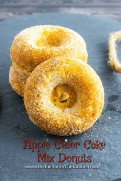 three apple cider cake mix donuts on a slate board