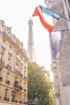 the eiffel tower is in the distance behind some buildings