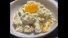 a white bowl filled with food on top of a table