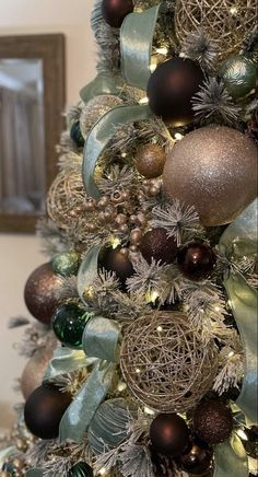 a christmas tree decorated with ornaments and ribbons