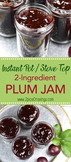 jars filled with plum jam sitting on top of a metal tray next to green leaves