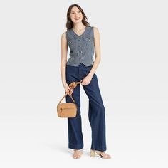 This Button-Front Denim Vest from Universal Thread™ will make a cool addition to your denim collection. Made from midweight cotton fabric with added stretch in a regular fit, it offers comfortable all-day wear. The flattering V-neckline, button-front design and chest flap pockets add touches of classic style. You can wear this sleeveless denim vest with high-waist pants, skirts and more for a variety of chic ensembles. Universal Thread™: Found exclusively at Target. Medium Wash Cotton Jeans With Snap Buttons, Cotton Jeans With Snap Buttons In Medium Wash, Trendy Cotton Denim Vest With Snap Buttons, Spring Cotton Denim Vest With Snap Buttons, Casual Denim Vest With Pockets For Workwear, Casual Everyday Denim Blue Top, Everyday Cotton Denim Top With Button Closure, Casual Cotton Denim Vest With Buttons, Trendy Denim Blue Vest With Button Closure