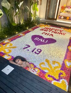 a birthday cake is on display in front of a woman's head and name